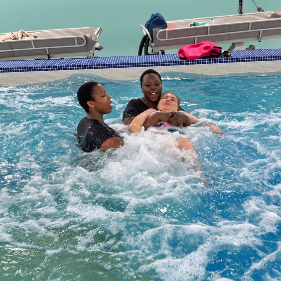 Members and a staff member together in the hydrotherapy pool.